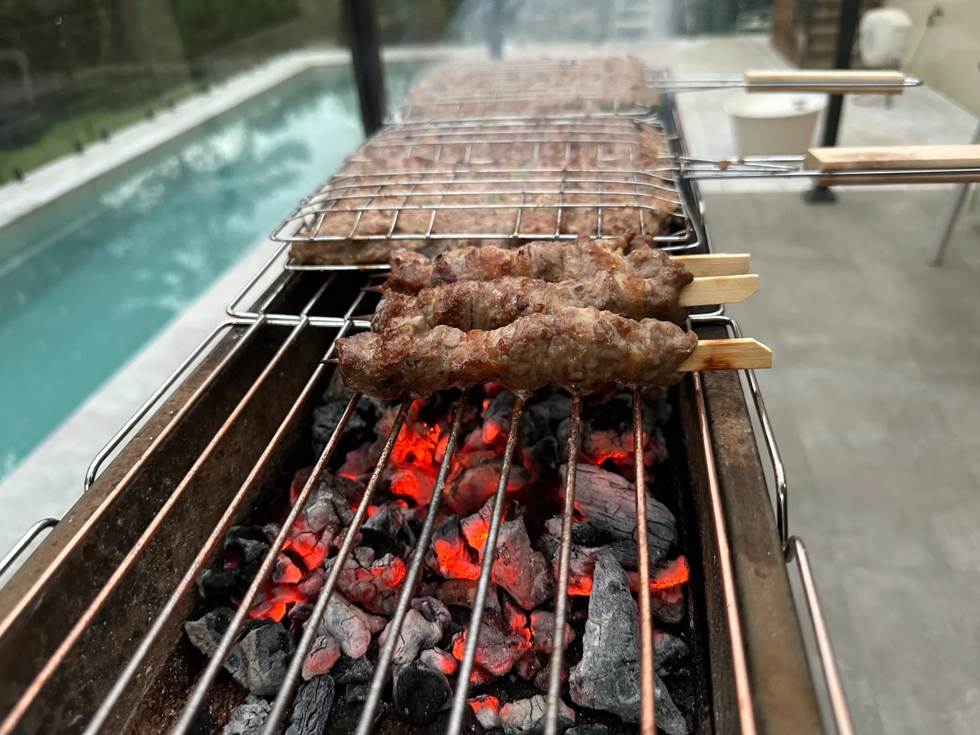 Beef skewers cooking over charcoal